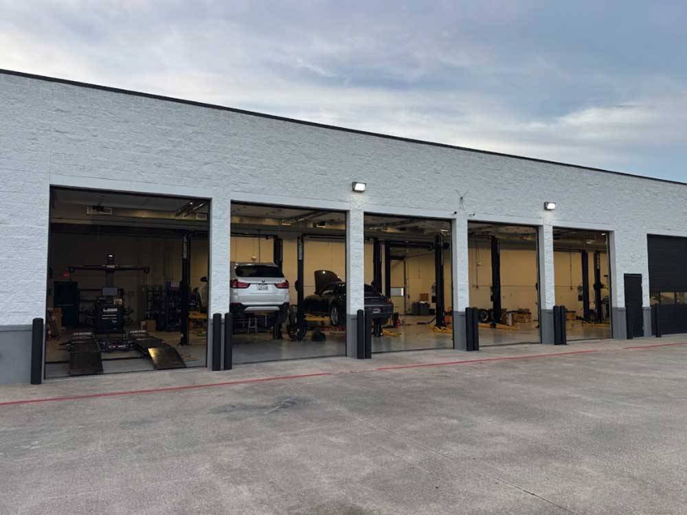 Car repair garage with vehicles inside service bays.